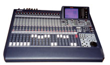Here is a closeup picture of the mixing console.
It has traditional faders, a few buttons, and a lot of lights!