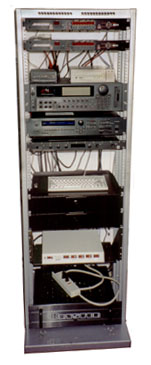 Here is a picture of a rack of 
synthesizers, which includes a computer keyboard that controls the sampler.